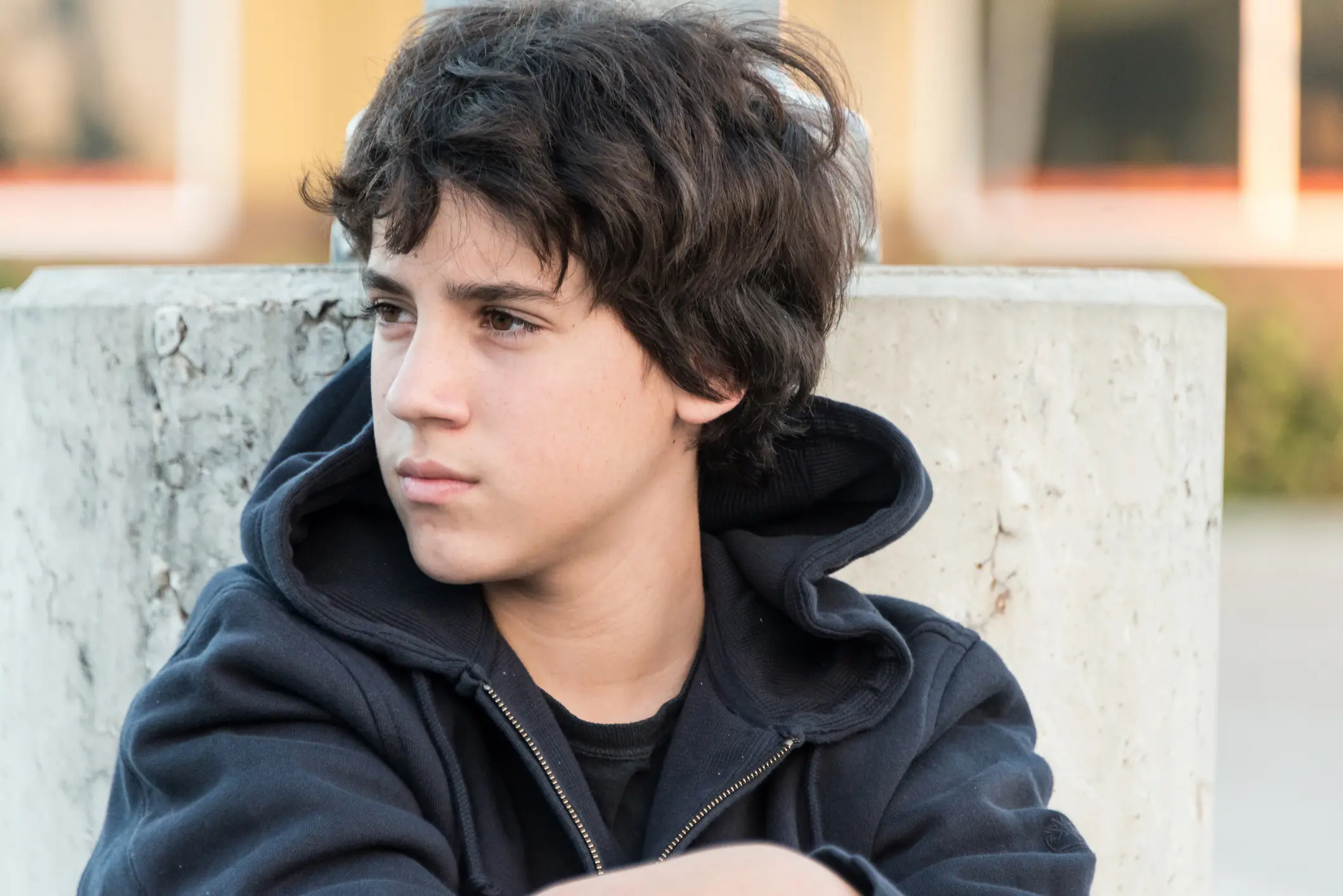 Teen boy looking away.